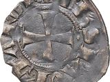 a silver coin with a cross on it