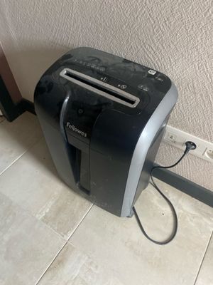 a black and silver toaster sitting on the floor next to a wall