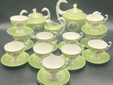 many cups and saucers sitting on the table
