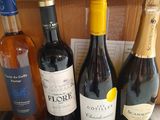 several bottles of wine are lined up on a wooden table