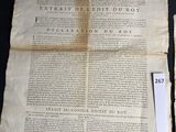 an old newspaper with a cross on it sitting on a table