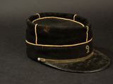 an old black hat on a black background with a leather band