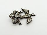 une image représentant une petite broche ornée d'un nœud