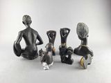five figurines of a man and a woman sitting next to each other