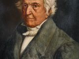 portrait of an old man in a green jacket and white shirt
