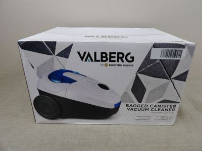 la boîte de l'aspirateur est ouverte sur la table
