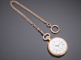 an image of a gold pocket watch with a chain on a gray background