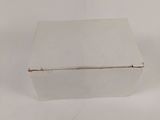 an empty white box sitting on top of a white table