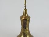 an old brass bell with a wooden handle on a white background
