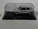 a small toy car in a glass case on a table