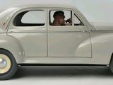 a toy car with a man sitting in the driver ' s seat