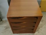 an image of a wooden chest of drawers in a room