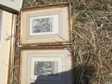 two framed pictures on the ground next to each other