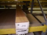 a box of wood sitting on a shelf in a warehouse