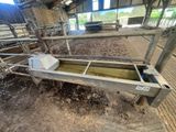 an image of a trough in a barn with a lot of dirt