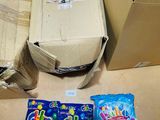 a box of candy and a bag of candy sitting on the floor