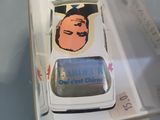 a toy car with a sticker on it in a clear box