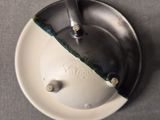 a white plate with a black and green design on it
