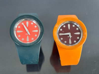 two watches sitting next to each other on a table