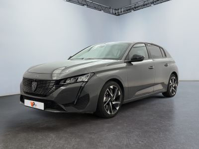 une voiture grise garée dans une grande pièce aux murs blancs