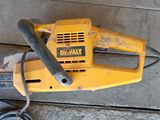a yellow and black corded electric tool on the ground