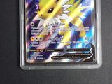 a close up of a pokemon card with a yellow and white face