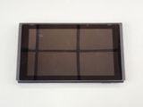 a glass tray with four squares on it on a white surface
