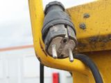 a close up of a yellow and black cable connected to a yellow pole