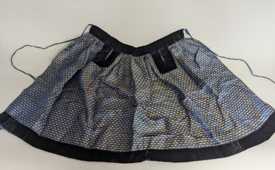 blue and black skirt on a white background with a black tie