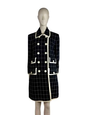 an image of a mannequin dressed in a black and white checkered coat