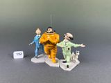 two figurines of a man and a dog on a base