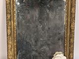 un miroir à cadre doré orné d'une rose blanche