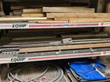 several pieces of wood are stacked on a shelf in a warehouse