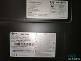 two labels on the back of a black refrigerator