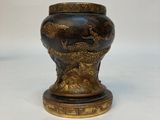 un vase noir et doré orné d'un dragon