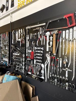 many tools hanging on the wall in the garage