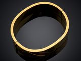 a close up of a gold ring on a black surface