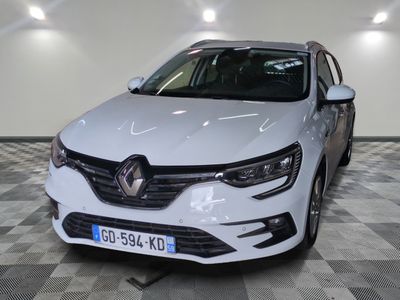 the front end of a white car in a room with checkered floor