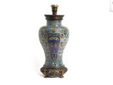 un vase bleu et vert posé sur une surface blanche