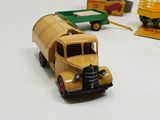 several toy trucks are lined up on a white surface
