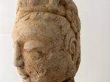 statue of a woman with a head of hair and a hat on her head