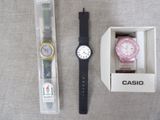 a watch in a box next to a watch in a box