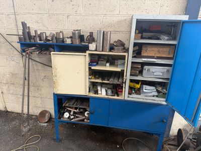 a blue cabinet with tools on it next to a wall