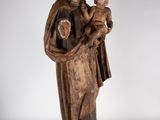 an old statue of a woman holding a baby and wearing a crown