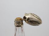 a bottle that has a silver object on top of it