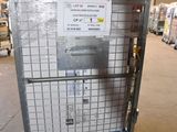 a metal cart with a sign on it in a warehouse