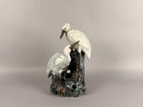 a white bird sitting on top of a tree stump