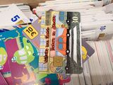 a pile of cards and a wallet with a picture of a car on it