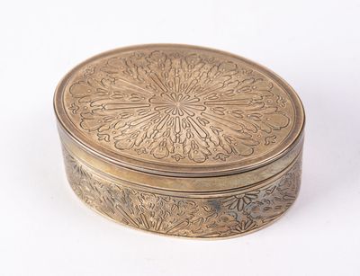 a gold box with a flower design on it