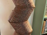 a tall sculpture made out of a spiral piece of wood